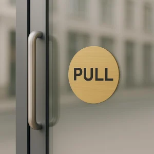 Brushed gold round push pull door sign – on a door