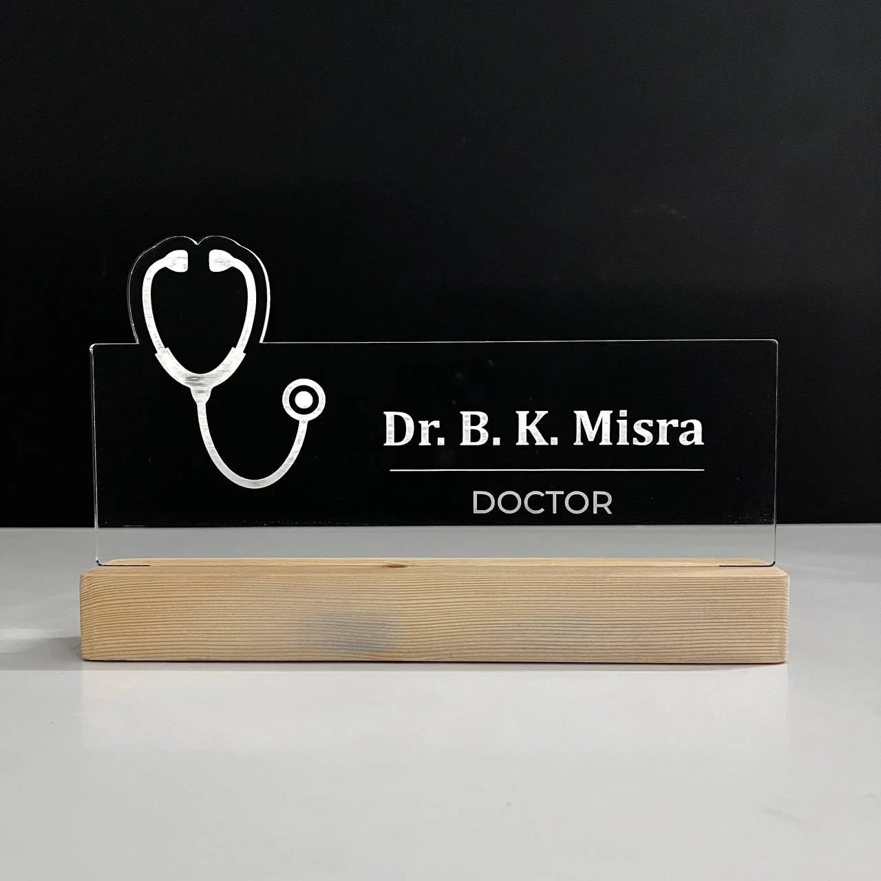 Personalised Name Lamp with Wooden Base for Doctors (Stethoscope) – 10 x 6 inch – glowing on a desk