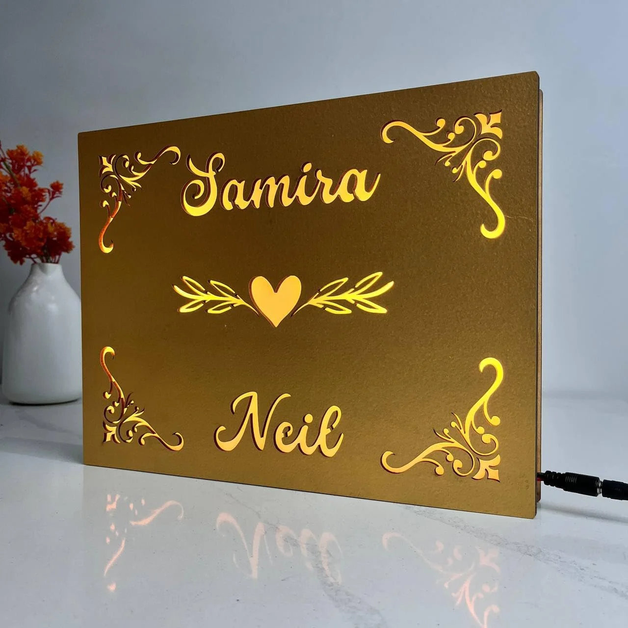 Golden floral couple name lamp – close-up